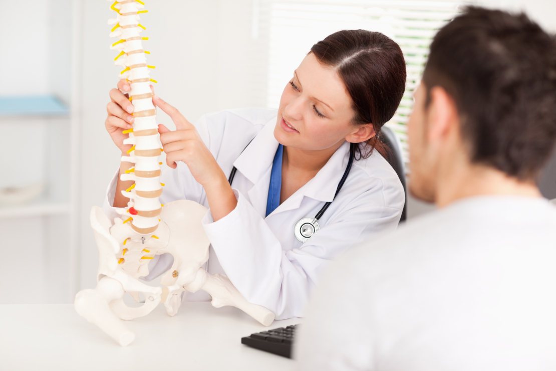 A Female Doctor Is Pointing On A Bone