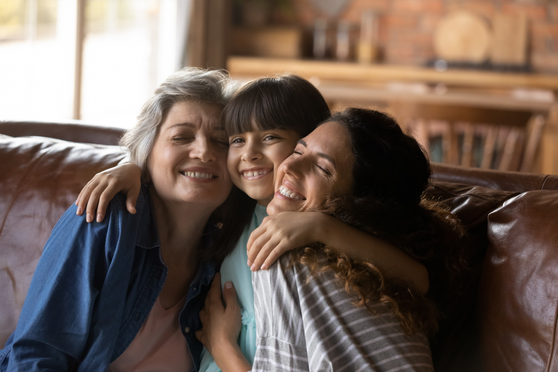 Three Female Generations Family Portrait. Cute Girl Hugging Tightly Beloved
