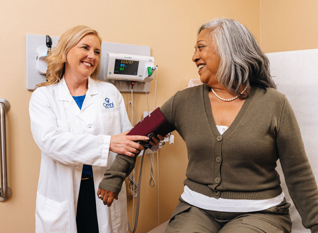 Provider taking patient's blood pressure