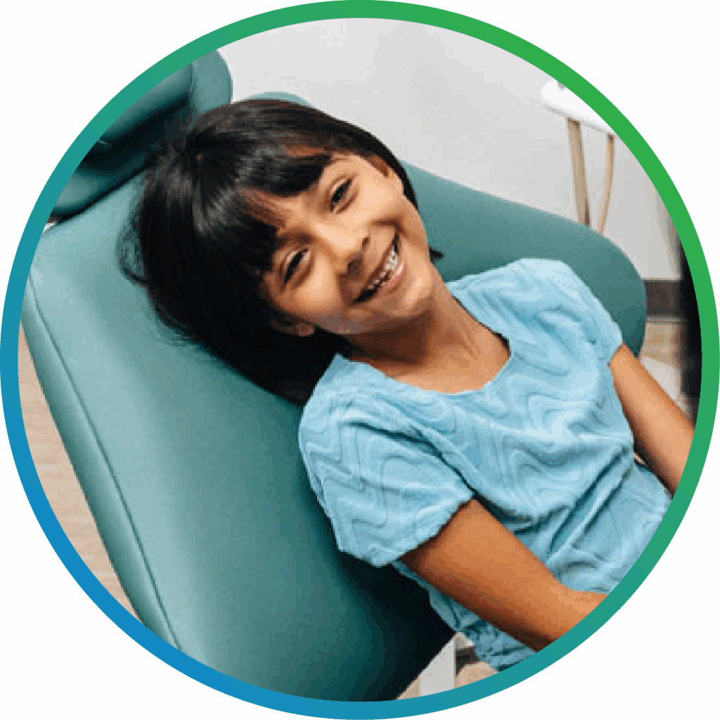 Child patient smiling in dentist chair