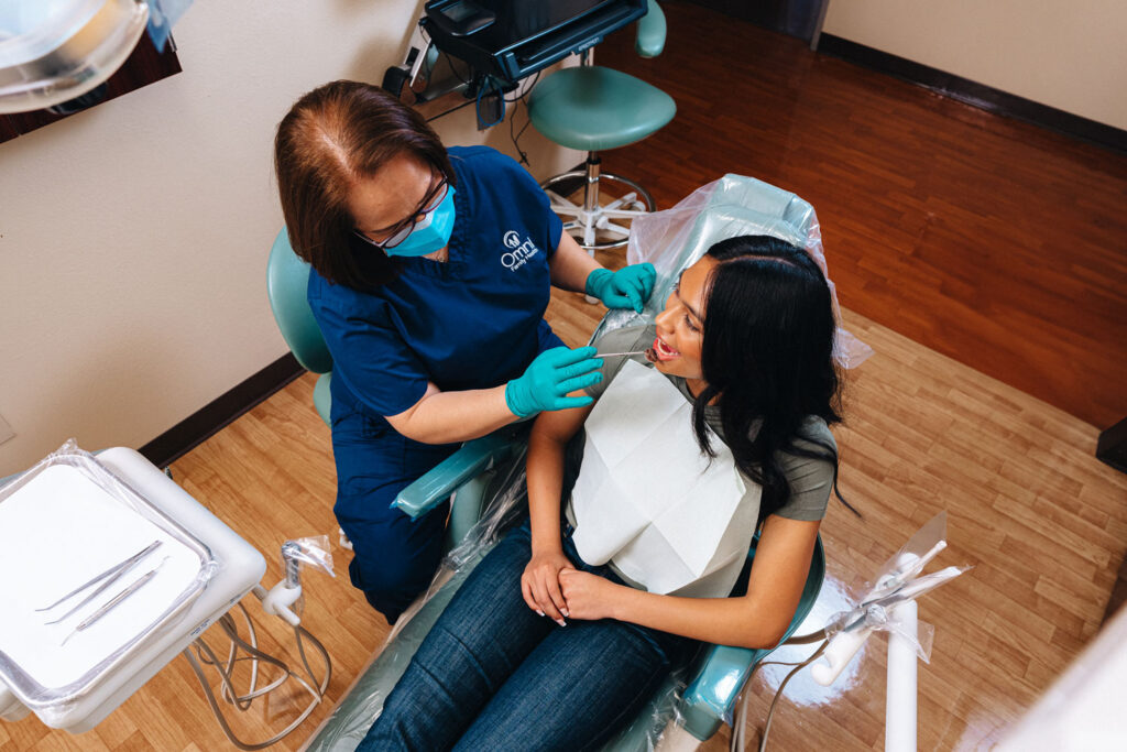 Dental Assistant checking patient's teeth